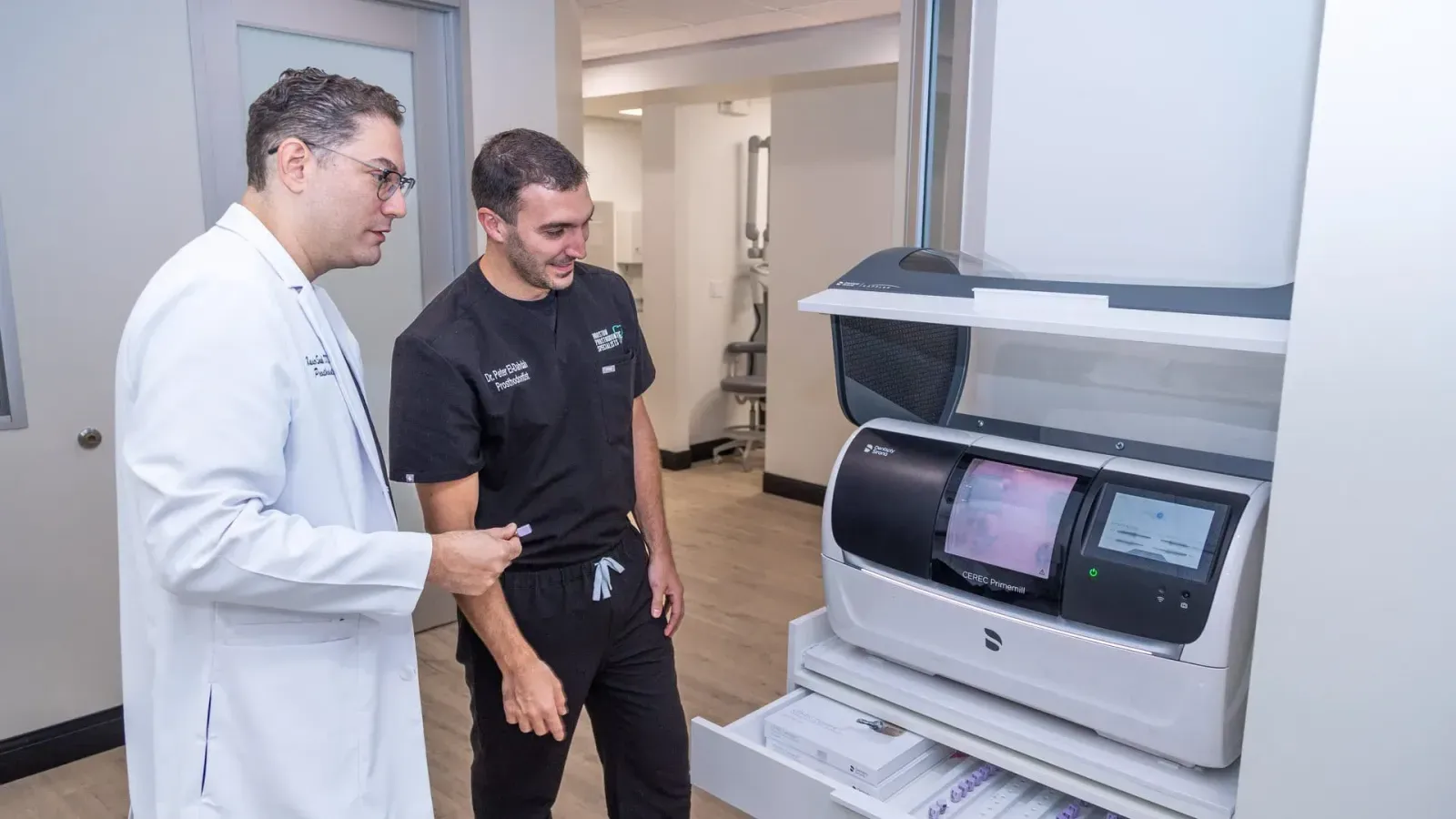 Dr. Saab and Dr. Eldahdah reviewing a digital dental scanner