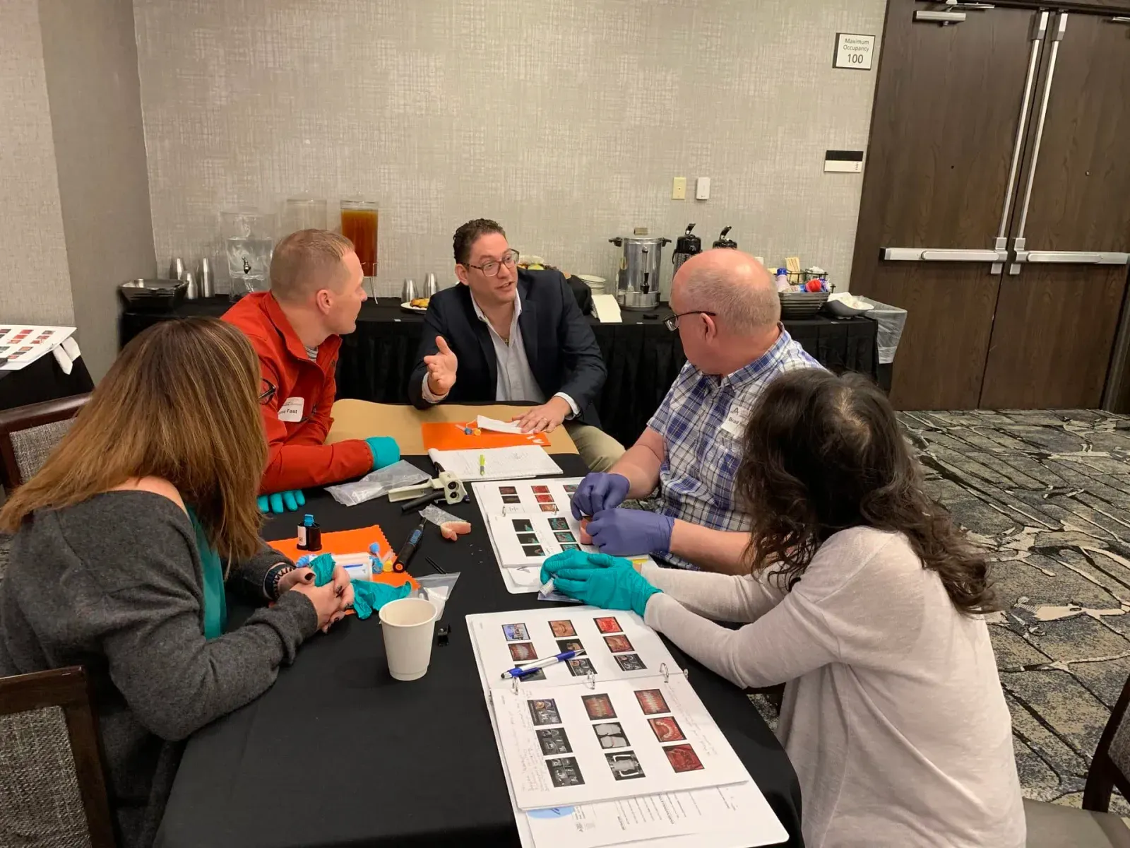 Dentists collaborating during a Saab Dental Training hands-on workshop