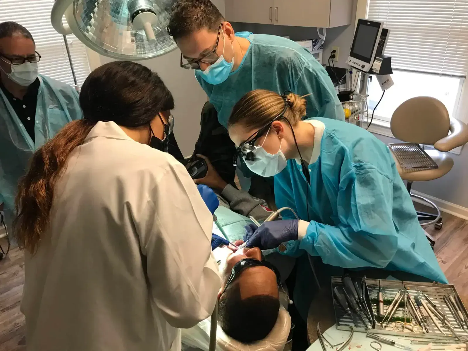 Saab Dental Training instructors guiding dentists through a live-patient implant procedure